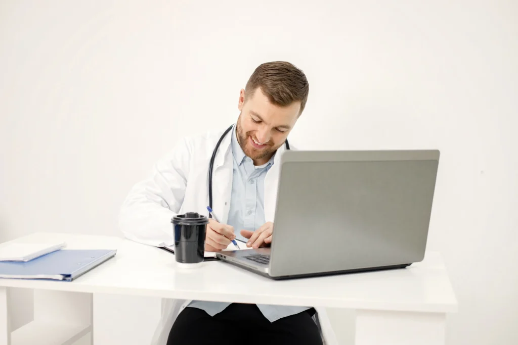 Médico revisando el cobro de sus cirugías con aseguradoras en su computadora